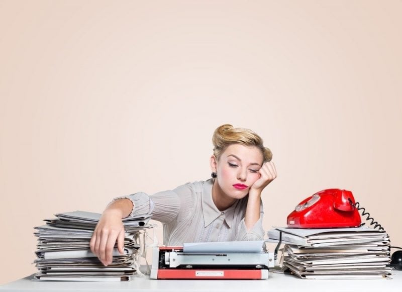 Woman at a cluttered desk