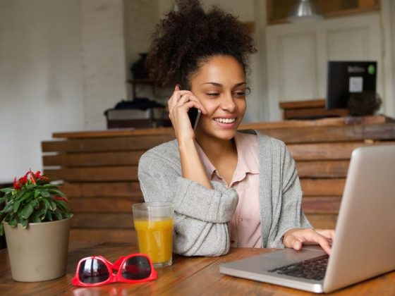 Mompreneur working on laptop while on the phone